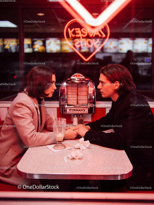 Couple Sharing Intimate Moment in Retro Diner