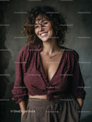 Confident Woman with Curly Hair Wearing Burgundy Blouse in Indoor Setting