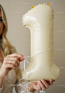 Woman Holding Gold Number One Balloon with Ribbon