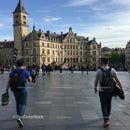 Bustling City Square with Tourists and Historic Building in European Town