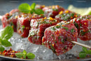 Juicy Marinated Beef Skewers on Ice with Fresh Herbs