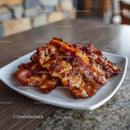 Crispy Bacon Strips served on White Plate in Rustic Setting