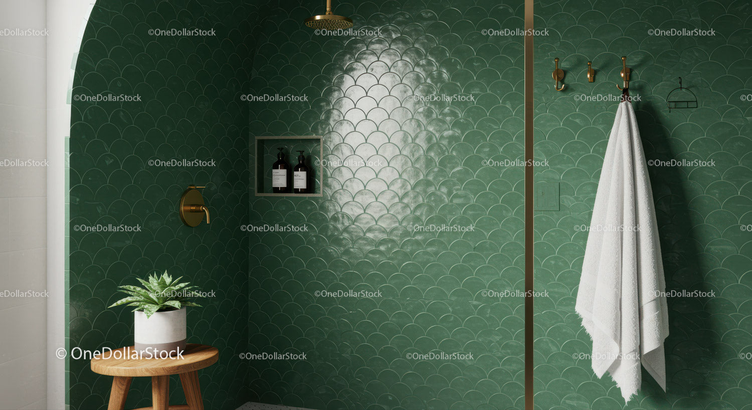 Minimalist green tiled bathroom with brass fixtures and plants