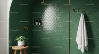 Minimalist green tiled bathroom with brass fixtures and plants