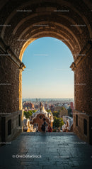 Stone Arch Frame Overlooking Cityscape With Towering Buildings and Scenic Sky