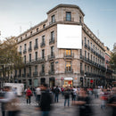 Crowded urban street corner with historic building facade
