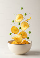 Crispy Potato Chips and Green Peas Floating in Bowl