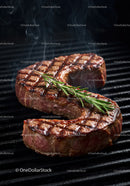 Juicy grilled steak with fresh rosemary on barbecue grill