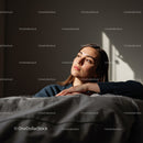 Serene Young Woman Relaxing Indoors with Sunlight Casting Shadows