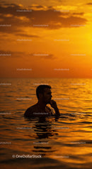 Serene Man Swimming in Ocean During Vibrant Sunset