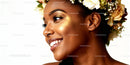 Smiling woman with floral crown and radiant makeup