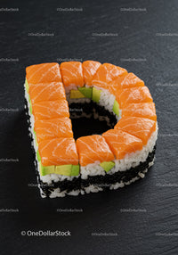 Salmon and avocado sushi roll shaped like letter D
