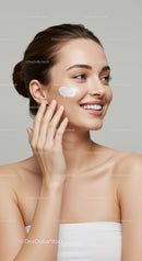 Portrait of a Smiling Woman Applying Cream for Skincare Routine
