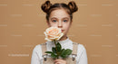 Girl Holding a Beautiful Peach Rose in a Cozy Setting