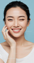 Smiling Girl with Short Black Hair and Clear Skin on Blue Background