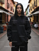 Fashionable Woman Wearing Black Hoodie in Urban City Street