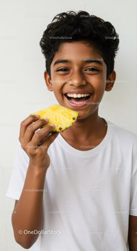 Smiling Boy Holding Pineapple Showing Joy with Tropical Fruit