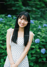 Young Woman Smiling in Garden with Blue Hydrangeas