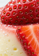Close up of fresh strawberries with sugar on creamy dessert