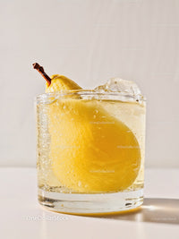 Refreshing pear infused sparkling water on white surface
