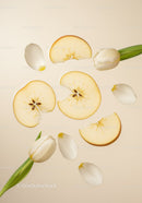 Delicate white tulips with sliced apple on beige background