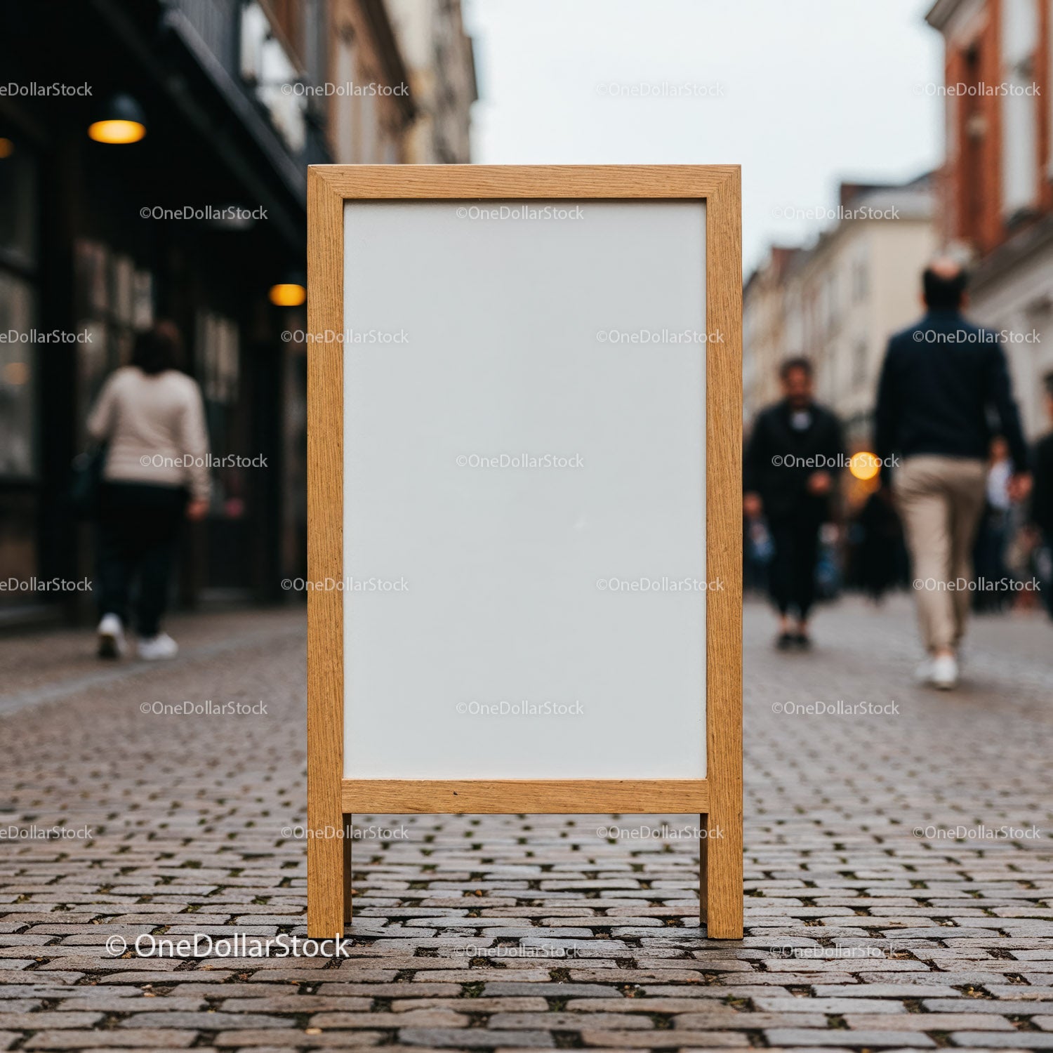 Blank wooden sandwich board on busy cobblestone street