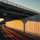 Sunset Urban Highway with Light Trails and Overpass in Cityscape