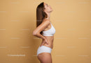 Young Woman in White Sportswear with Toned Body and Confident Pose