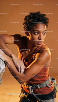 Focused woman preparing for rock climbing challenge