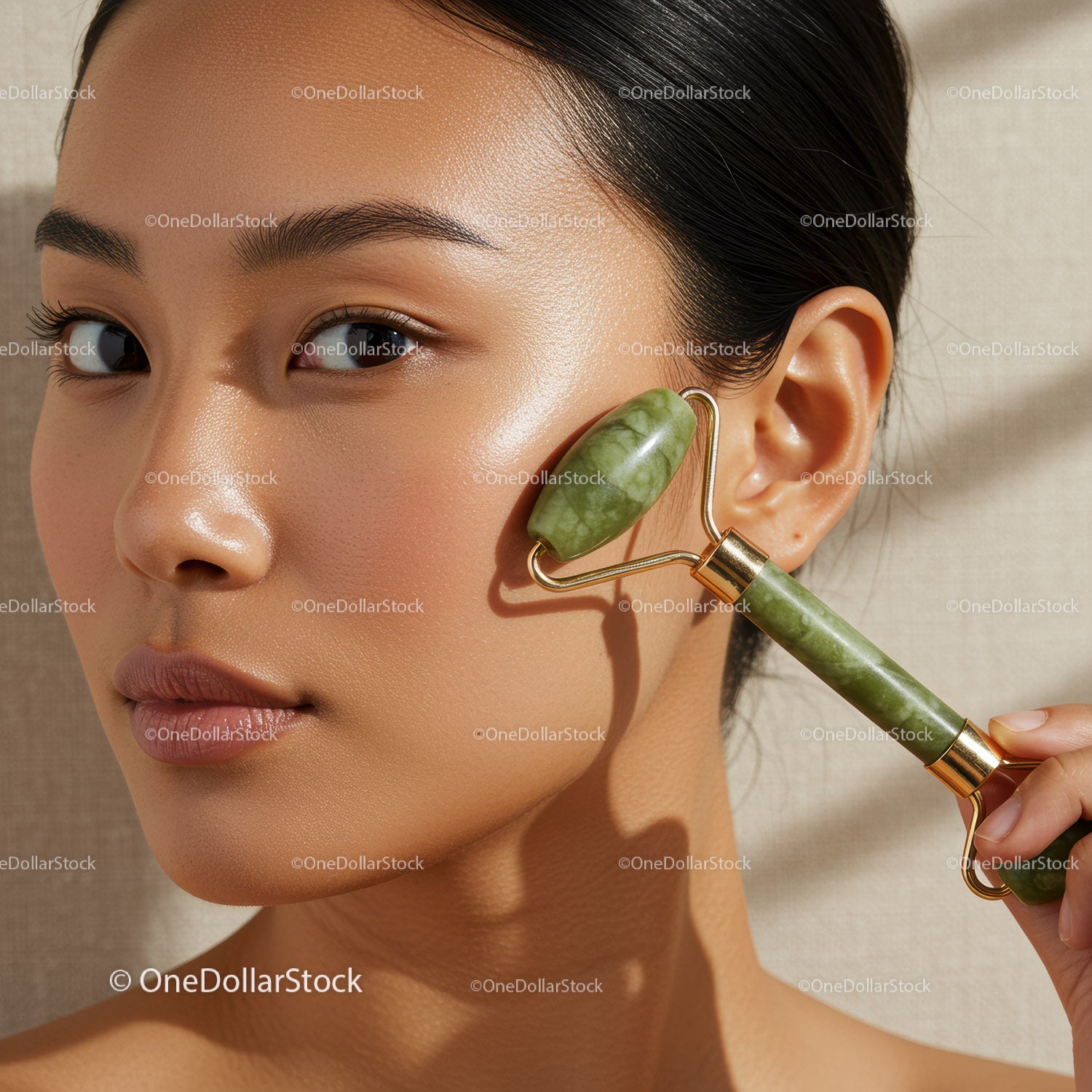 Asian Woman Using Jade Roller for Facial Skincare and Beauty