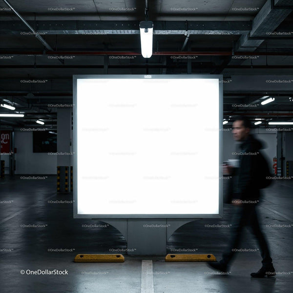 Blurred Man Walking Past Illuminated Blank Billboard in Garage JPG Mockup Image