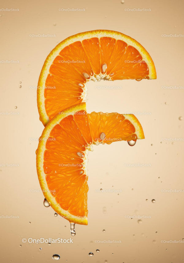 Fresh orange slices with water droplets on beige background
