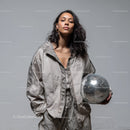 Stylish Woman in Metallic Outfit Holding Disco Ball for Modern Fashion