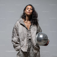 Stylish Woman in Metallic Outfit Holding Disco Ball for Modern Fashion