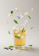 Refreshing iced tea with jasmine flowers and green leaves