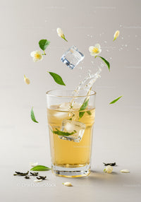 Refreshing iced tea with jasmine flowers and green leaves