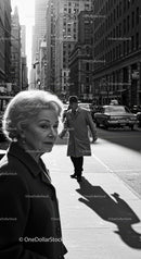 Vintage Elderly Woman Walking in City Street with Tall Skyscrapers
