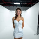 Young Woman in White Corset Dress Smiling in Studio Portrait