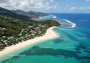 Tropical Coastal Scene with White Sand Beach and Lush Greenery