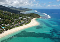 Tropical Coastal Scene with White Sand Beach and Lush Greenery