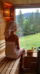 Relaxing Woman Sitting in Sauna with Scenic Forest View