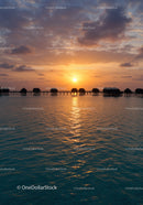 Sunset Overwater Bungalows with Colorful Sky and Calm Ocean