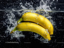 Fresh Ripe Yellow Bananas Splashing in Water