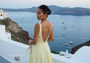 Woman in elegant dress overlooking peaceful sea view