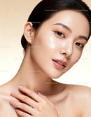 Close-up of woman with glowing skin and cream application