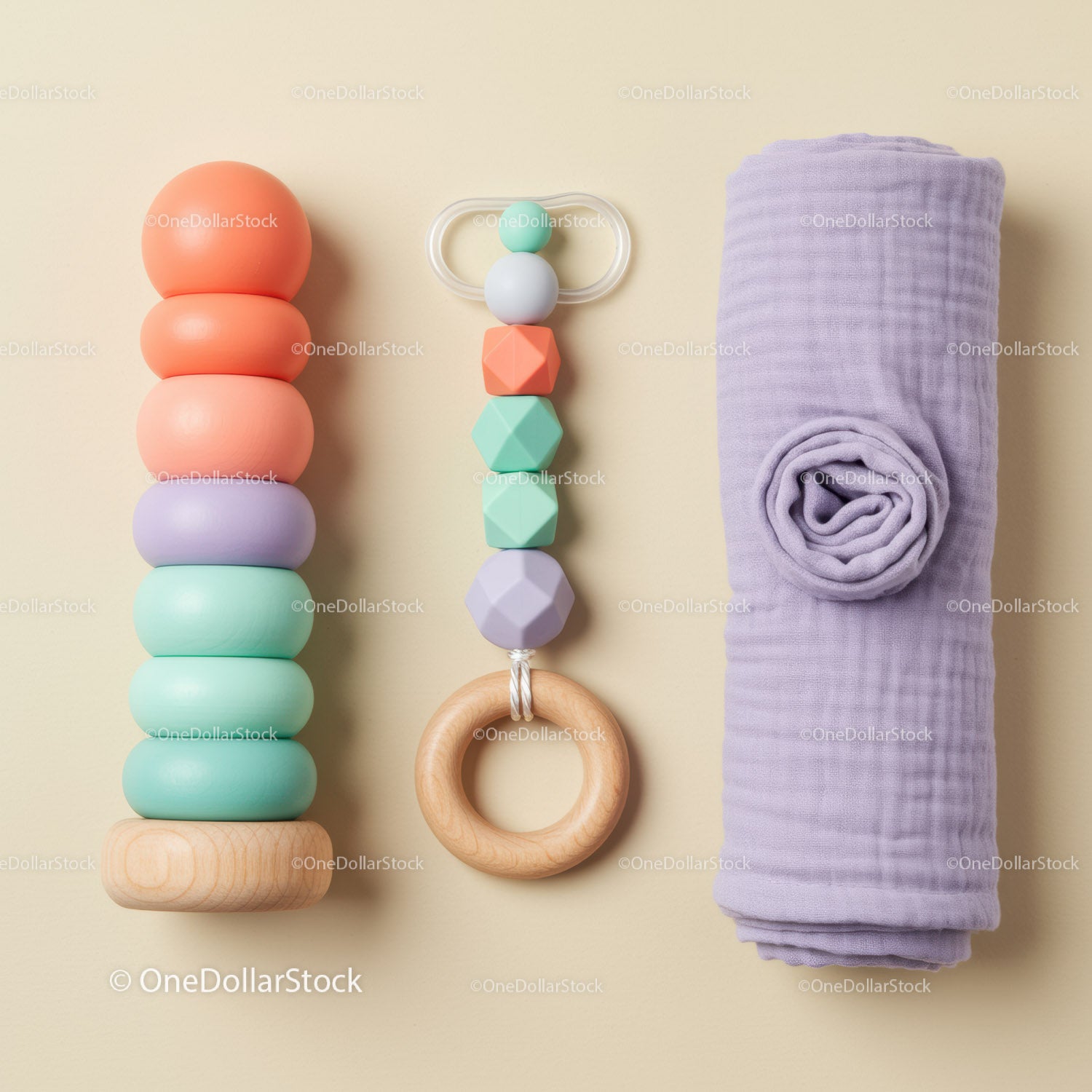Colorful baby toys and soft swaddle on beige background