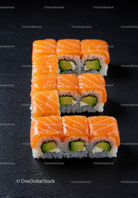 Fresh Salmon Sushi Rolls Arranged on Black Slate Plate