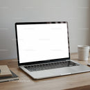 Modern laptop with blank screen and coffee cup on desk
