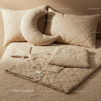 Cozy beige quilted bedding with crescent moon pillow