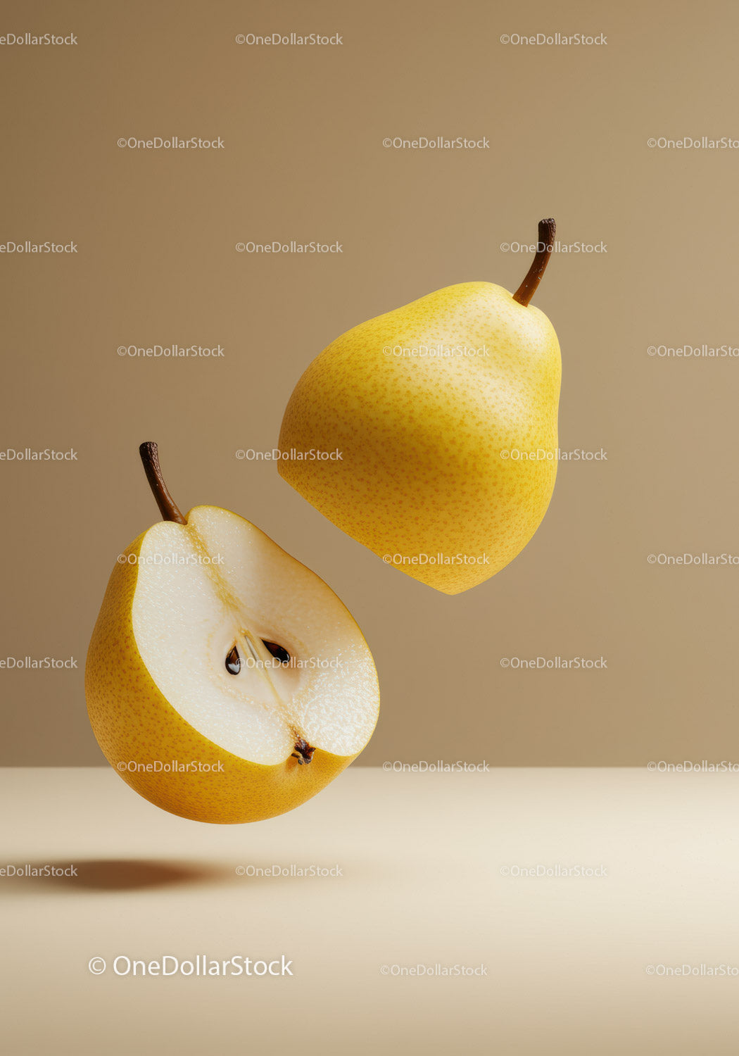 Fresh yellow pears with one cut in half on beige background